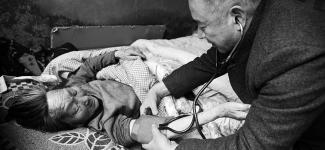 Doctor taking patient's blood pressure reading