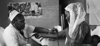 Doctor measuring woman's blood pressure