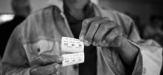 Man displays blood pressure readings on paper